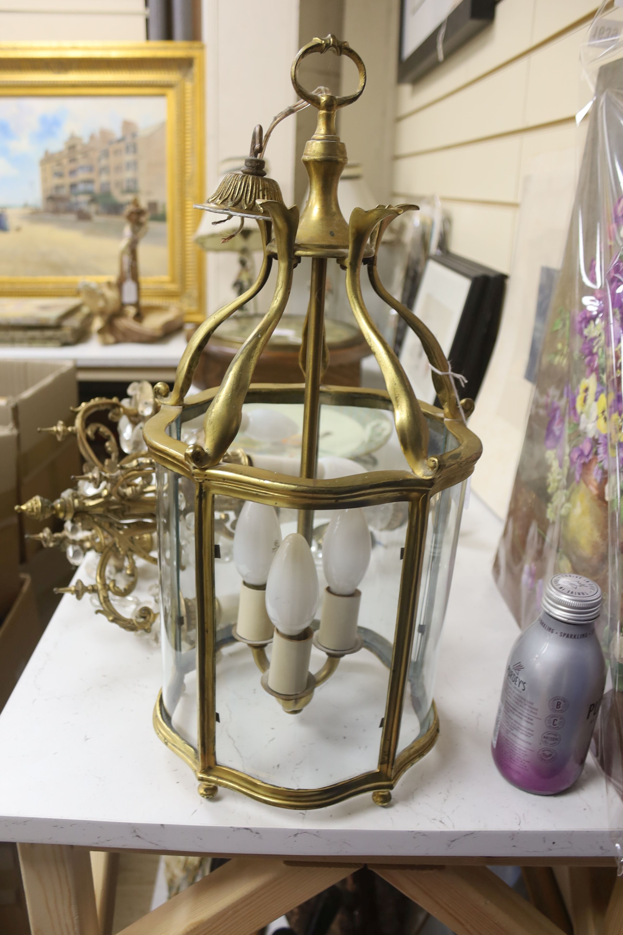 An early 20th century gilt brass hall lantern, height 49cm, and a gilt metal lustre hung electrolier